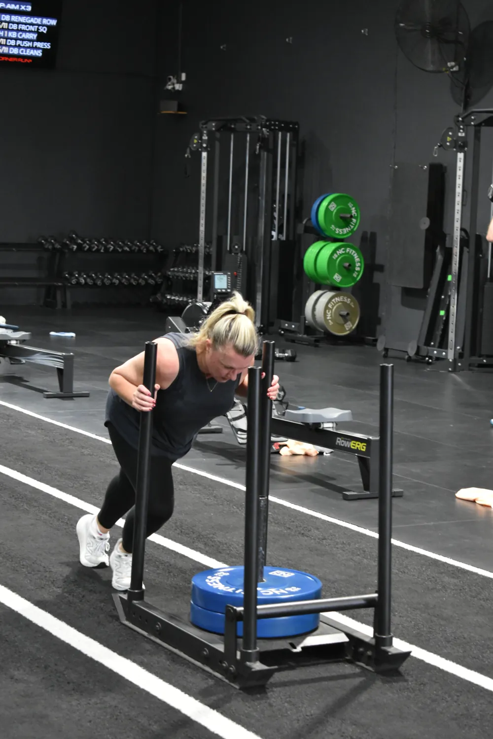 Member pushing the sled in a 6 Week Challenge session