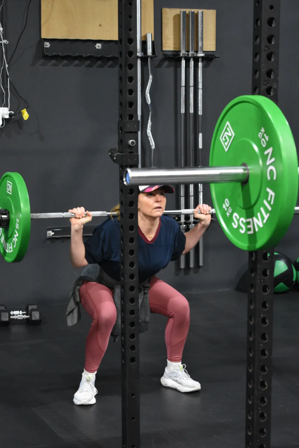 Member back squatting in a coached session